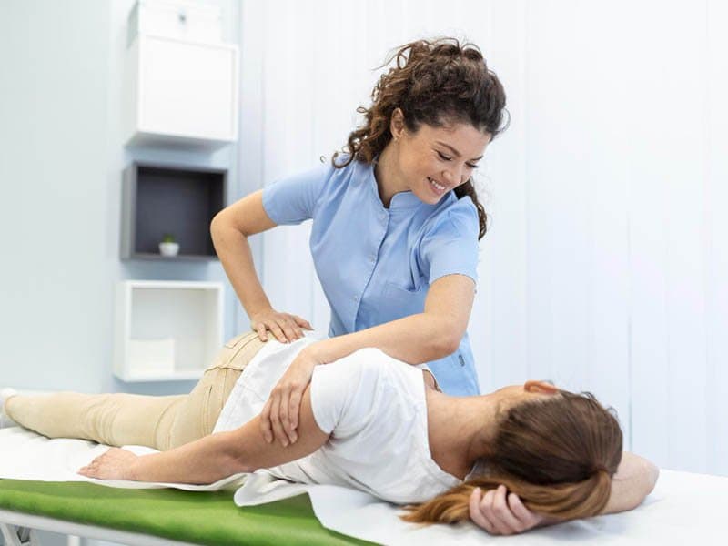 Chiropractor adjusting a patient's back in Huntington Beach, CA